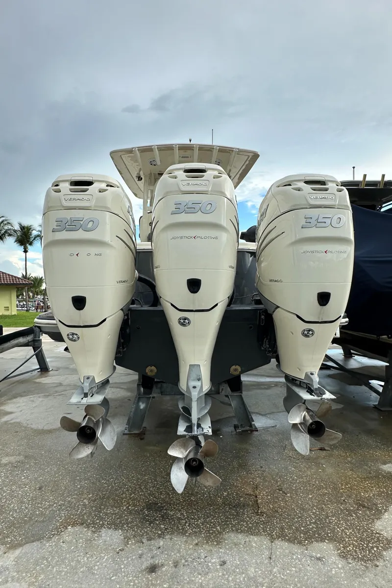 Slide: The Image of 2017 Scout 350 LXF boat with triple outboard engines, rear view. - 15