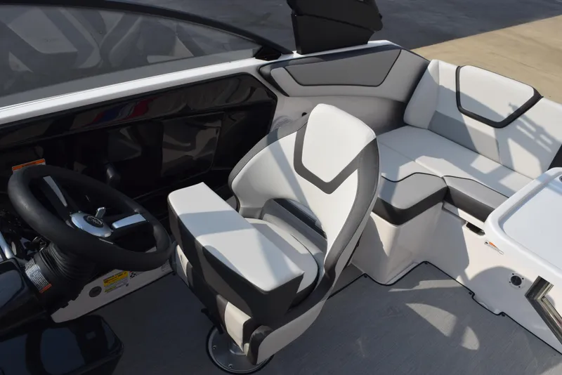Slide: The Image of 2025 Yamaha Boats AR220 interior with modern seating and steering wheel. - 11