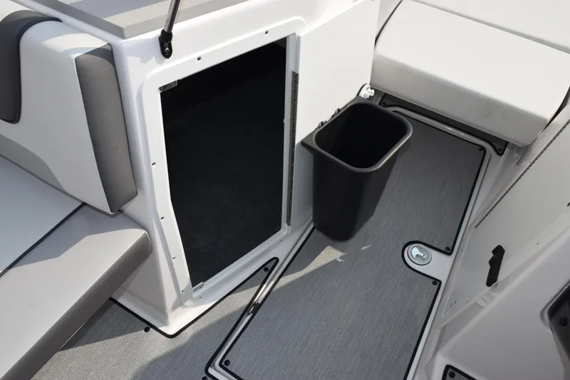 Slide: The Image of 2025 Yamaha Boats AR220 interior with storage compartment and trash bin. - 15