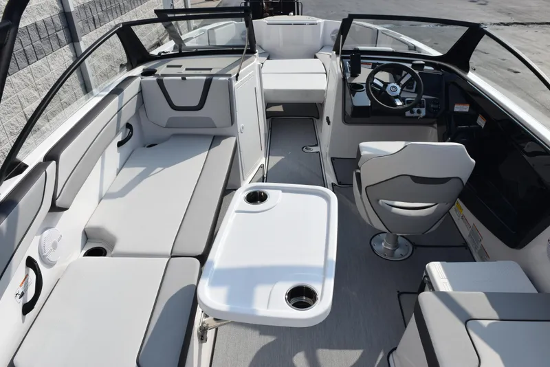 Slide: The Image of 2025 Yamaha Boats AR220 interior with seating, steering wheel, and table. - 7