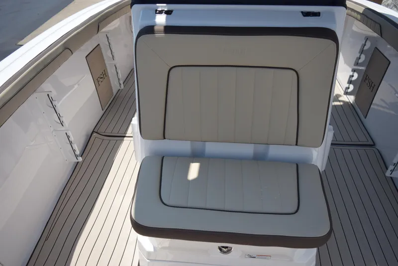Slide: The Image of 2025 Yamaha Boats 255 FSH Sport E interior seating with sleek design and beige upholstery. - 12