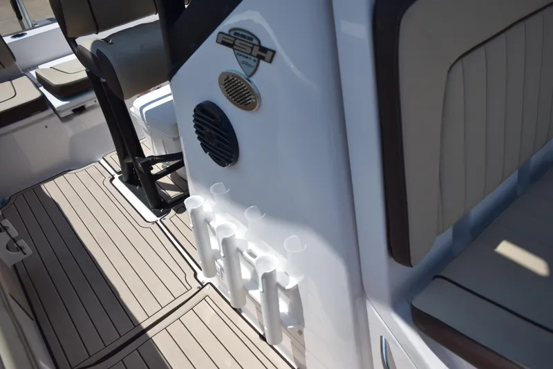Slide: The Image of 2025 Yamaha Boats 255 FSH Sport E interior with rod holders and seating. - 14