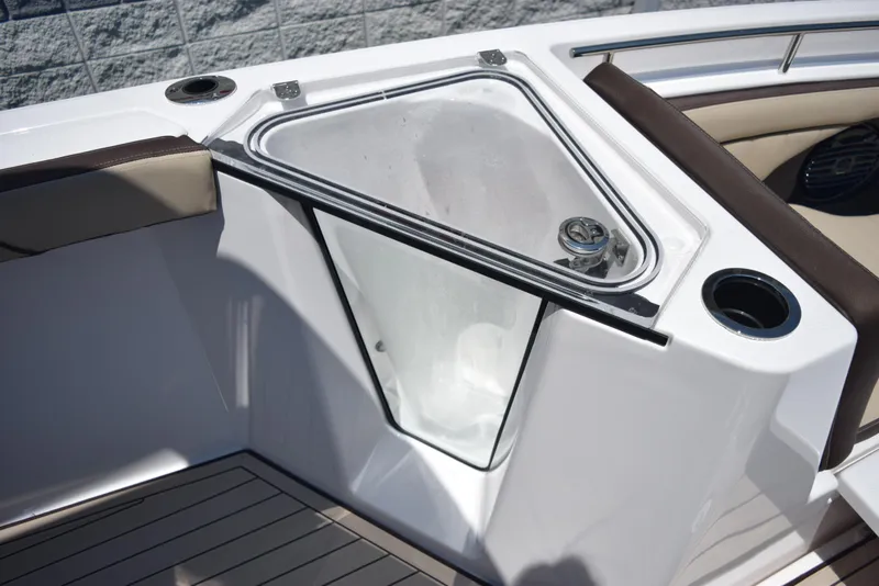 Slide: The Image of 2025 Yamaha Boats 255 FSH Sport E, interior detail with storage compartment and seating. - 16