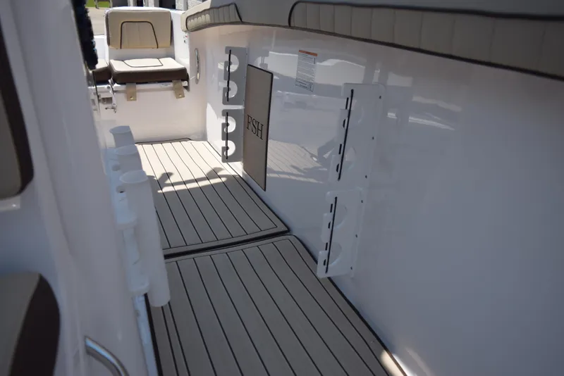 Slide: The Image of 2025 Yamaha Boats 255 FSH Sport E interior with sleek deck and seating. - 18