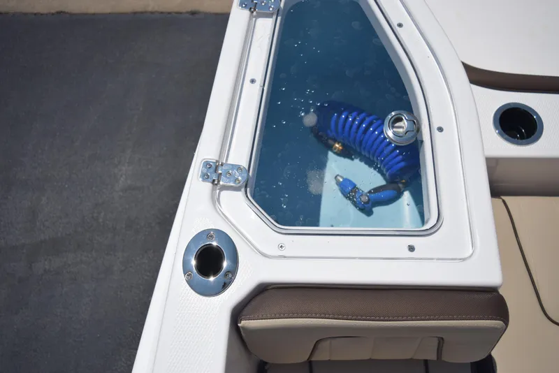 Slide: The Image of 2025 Yamaha Boats 255 FSH Sport E livewell with blue coiled hose. - 20