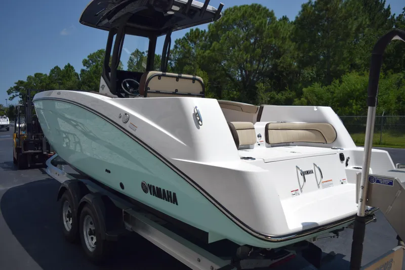 Slide: The Image of 2025 Yamaha Boats 255 FSH Sport E on trailer, sleek design, outdoor setting. - 4