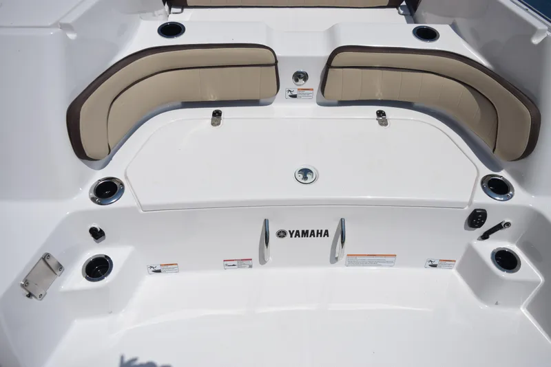 Slide: The Image of 2025 Yamaha Boats 255 FSH Sport E interior with seating and storage. - 5