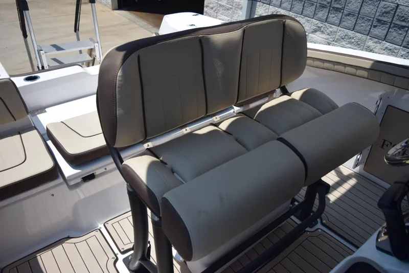 Slide: The Image of 2025 Yamaha Boats 255 FSH Sport E interior seating, featuring cushioned bench and sleek design. - 8