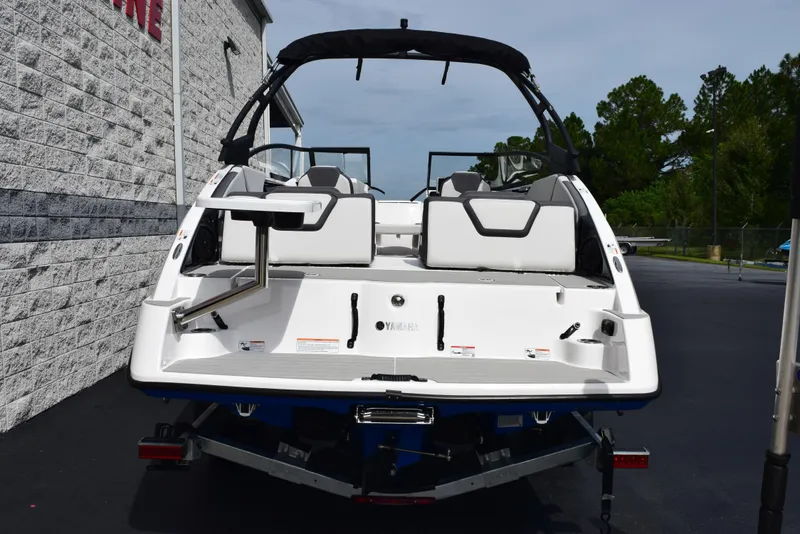 Slide: The Image of 2025 Yamaha Boats AR250, rear view, white exterior, parked outdoors. - 5