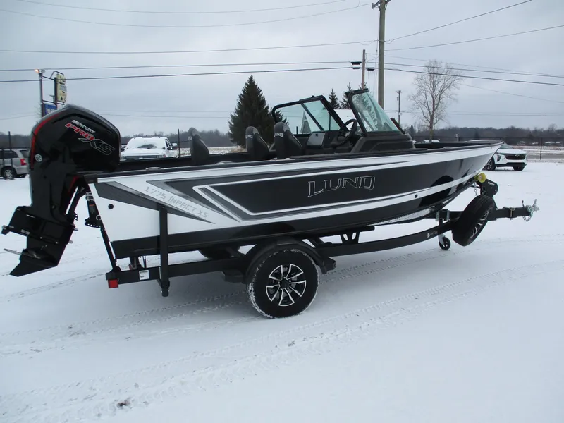 Slide: The Image of 2025 Lund Impact XS 1775 Sport boat on snowy ground, side view. - 12