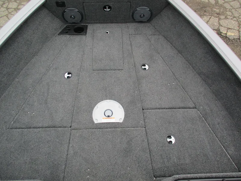 Slide: The Image of 2025 Lund Impact XS 1775 Sport boat interior with carpeted deck and storage compartments. - 5