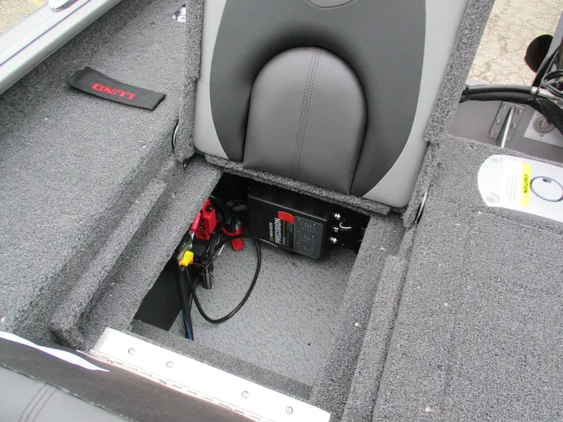 Slide: The Image of 2025 Lund Impact XS 1775 Sport boat interior with battery compartment. - 9