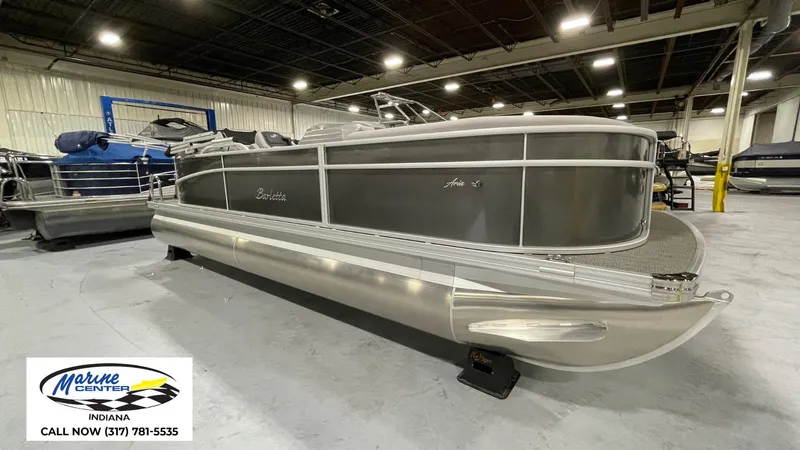 Slide: The Image of 2025 Barletta Aria A22QC pontoon boat displayed indoors at Marine Center Indiana. - 12