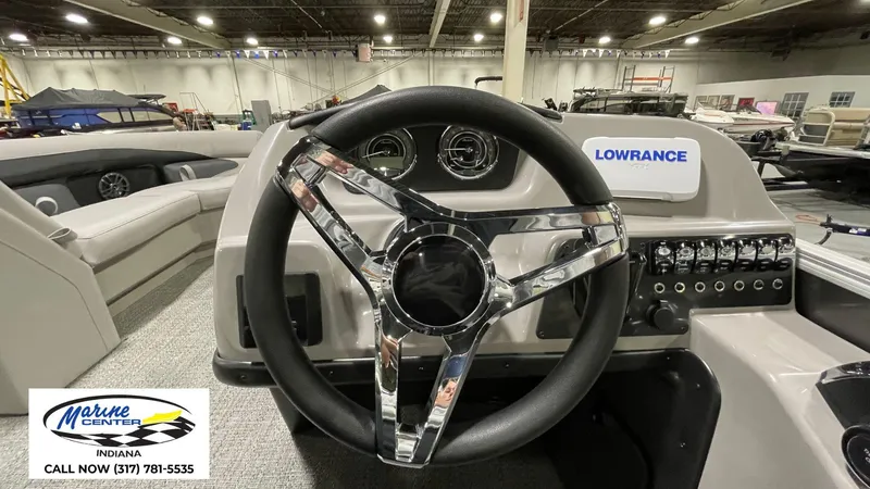 Slide: The Image of 2025 Barletta Aria A22QC boat dashboard with steering wheel and control panel. - 20