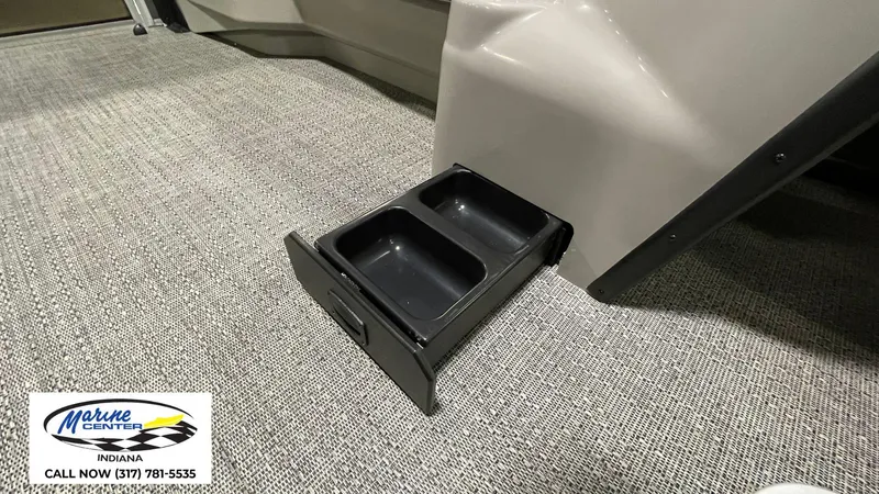 Slide: The Image of 2025 Barletta Aria A22QC boat with built-in cup holders on carpeted floor. - 22