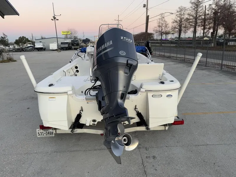 Slide: The Image of 2014 NauticStar NauticBay 214 XTS SB boat with Yamaha 150 engine, parked outdoors. - 11