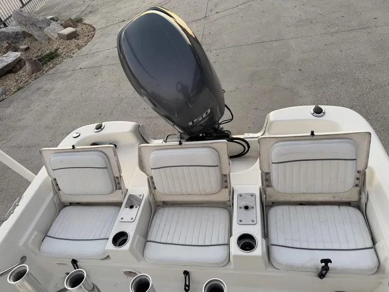 Slide: The Image of 2014 NauticStar NauticBay 214 XTS SB boat with three white seats and an outboard motor. - 13