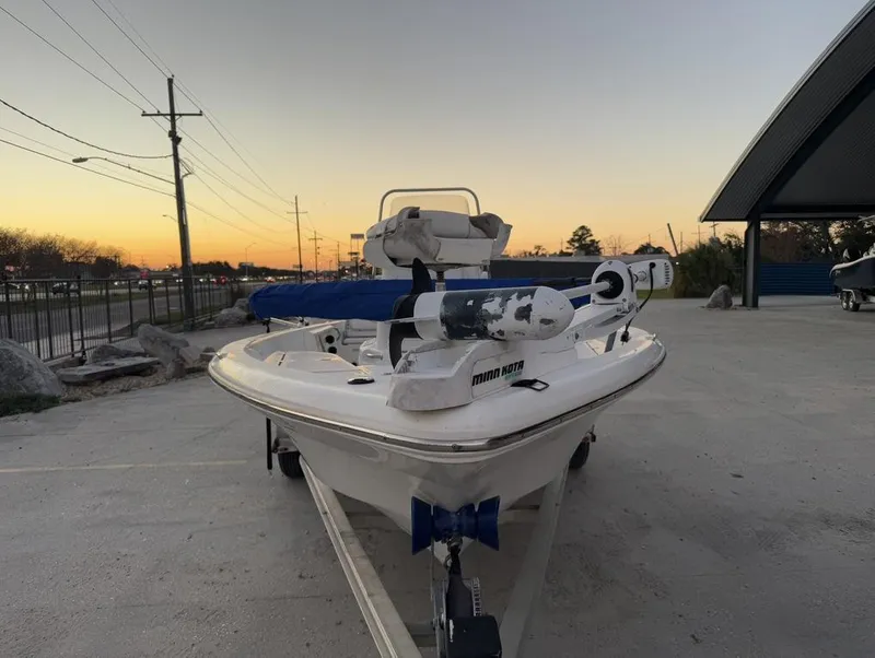 Slide: The Image of 2014 NauticStar NauticBay 214 XTS SB boat at sunset, parked on a trailer. - 4