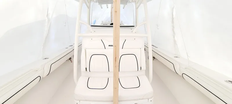 Slide: The Image of 2016 Regulator 34 boat interior with white seating and sleek design. - 13
