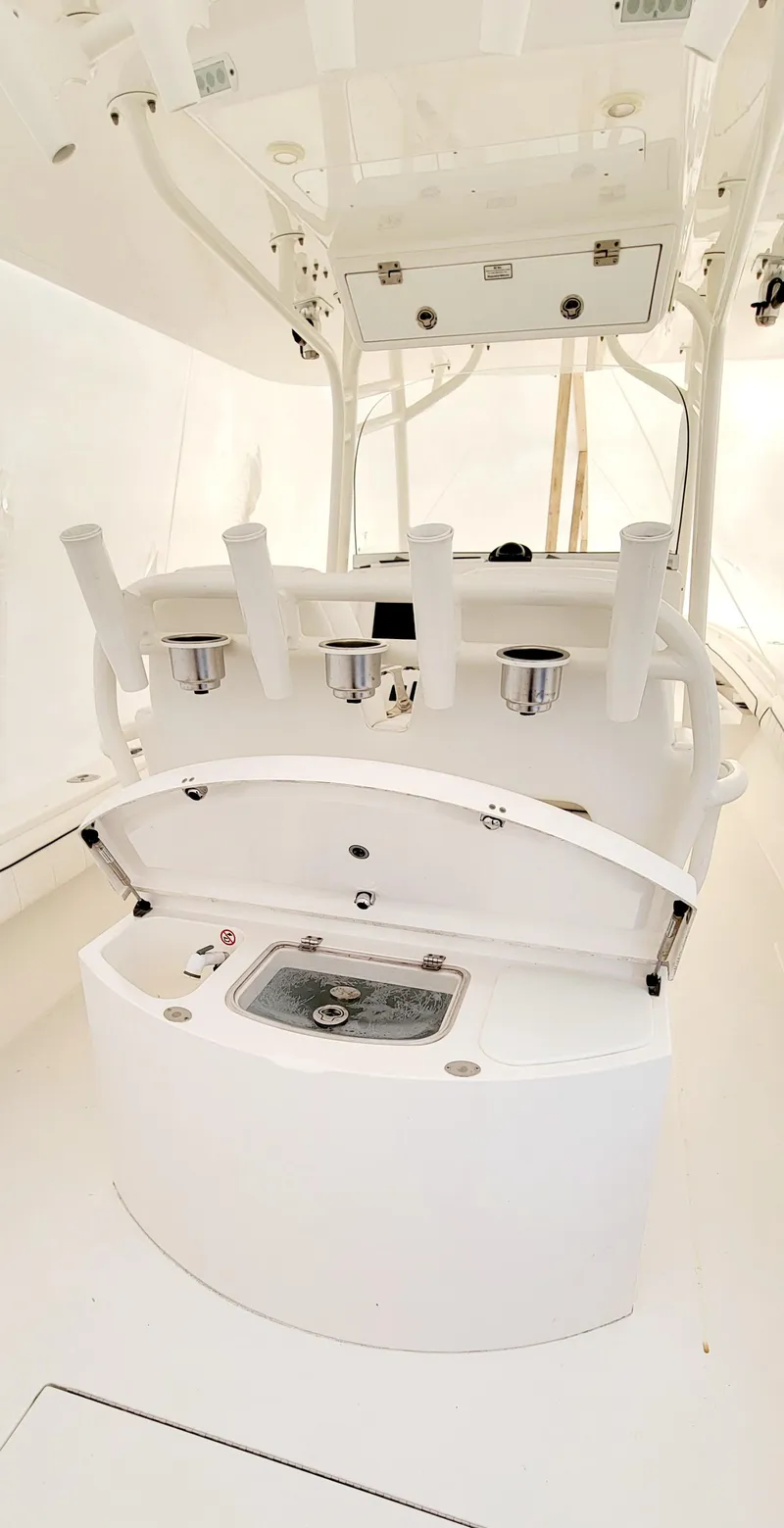 Slide: The Image of 2016 Regulator 34 boat interior with fishing rod holders and storage compartment. - 16
