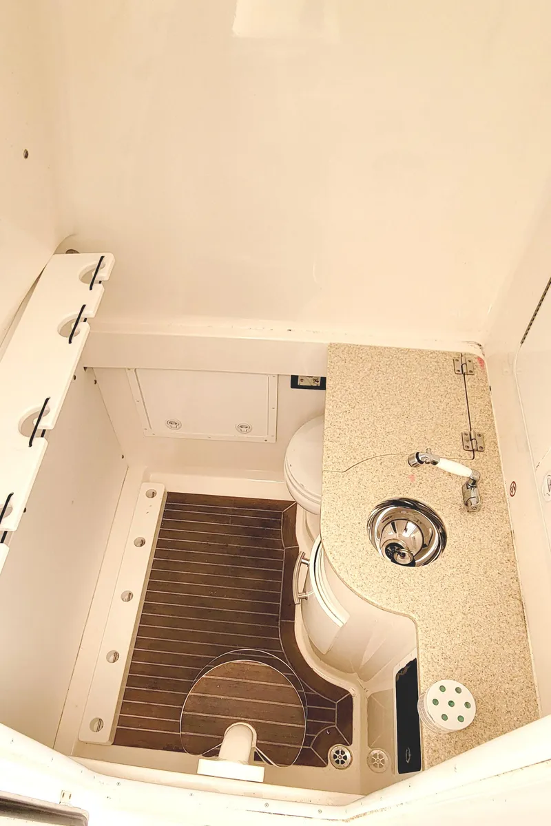 Slide: The Image of 2016 Regulator 34 boat interior with sink and wooden flooring. - 17