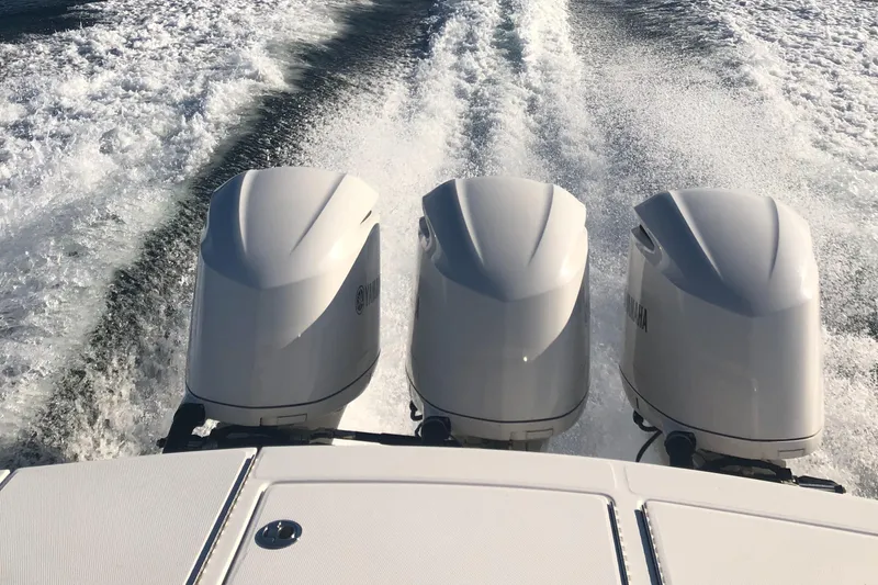 Slide: The Image of 2016 Regulator 34 boat with triple outboard engines on water. - 2