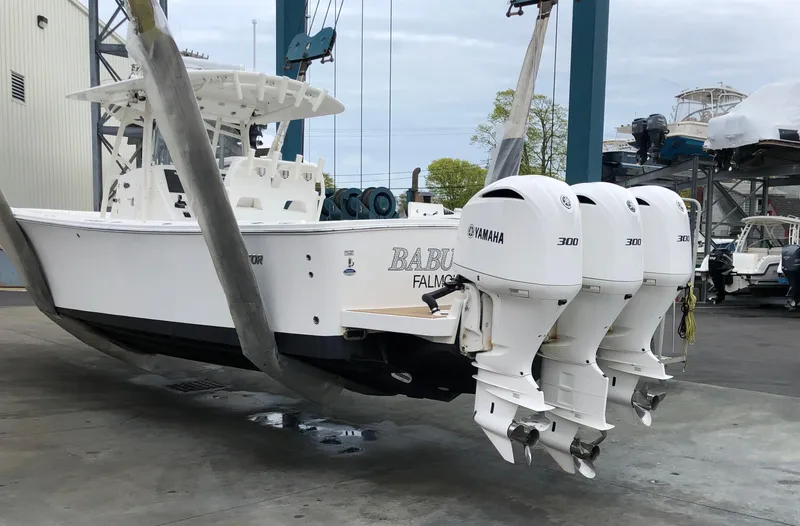 Slide: The Image of 2016 Regulator 34 boat with triple Yamaha 300 engines in a marina. - 3