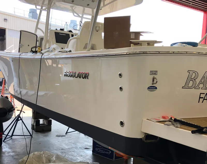 Slide: The Image of 2016 Regulator 34 boat in a workshop setting, undergoing maintenance. - 4