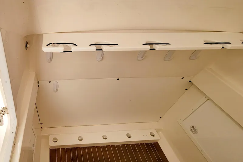 Slide: The Image of Interior of 2016 Regulator 34 boat, featuring rod holders and storage space. - 9