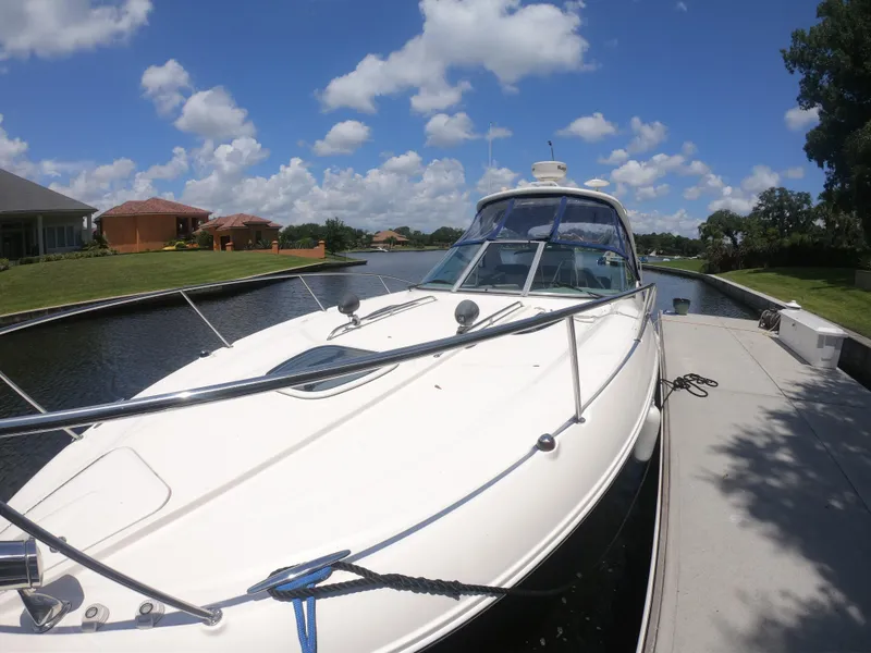 Slide: The Image of 2015 Sea Ray 330 Sundancer docked on a sunny day with blue skies. - 17