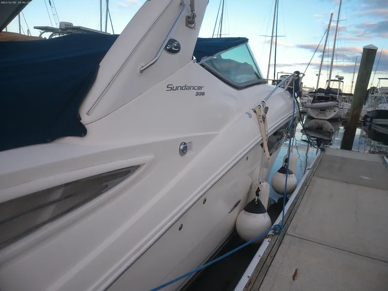 Slide: The Image of 2015 Sea Ray 330 Sundancer docked at marina with fenders. - 27
