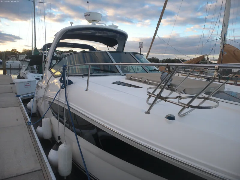 Slide: The Image of 2015 Sea Ray 330 Sundancer docked at marina under cloudy sky. - 28