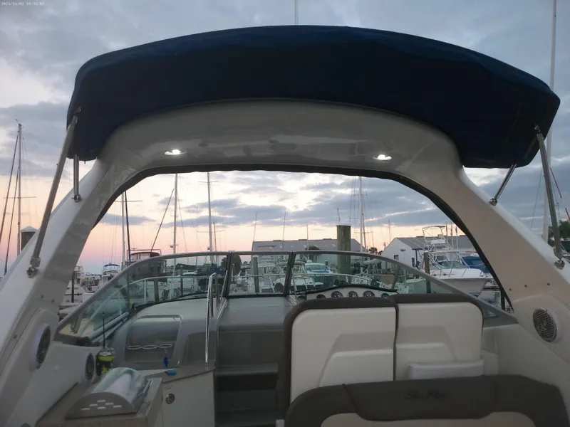 Slide: The Image of 2015 Sea Ray 330 Sundancer at marina during sunset, featuring cockpit and canopy. - 30