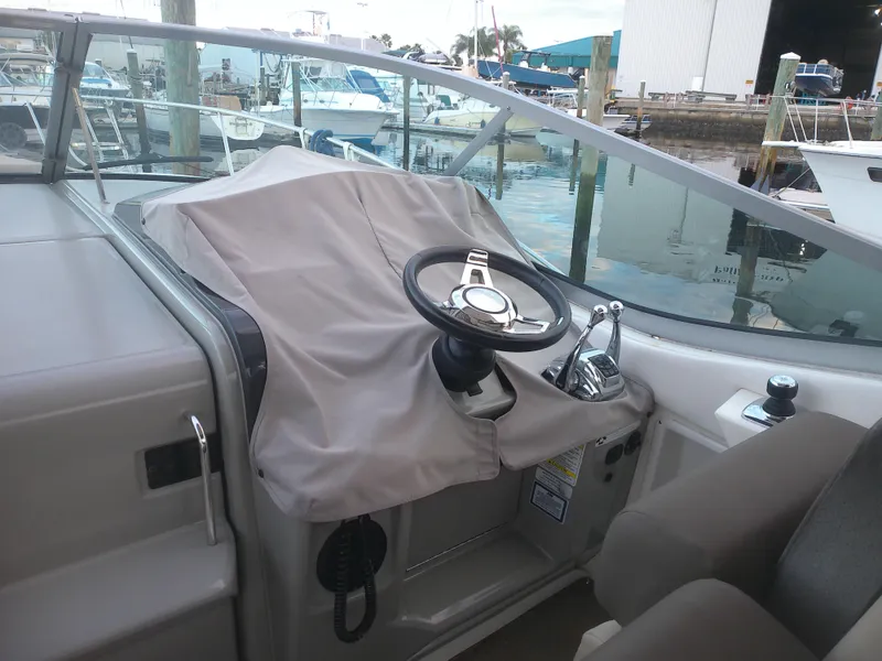 Slide: The Image of Helm of 2015 Sea Ray 330 Sundancer boat docked at marina. - 33