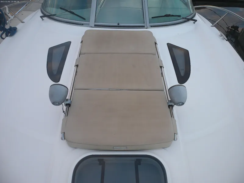 Slide: The Image of 2015 Sea Ray 330 Sundancer boat deck with beige sunpad and windows. - 35