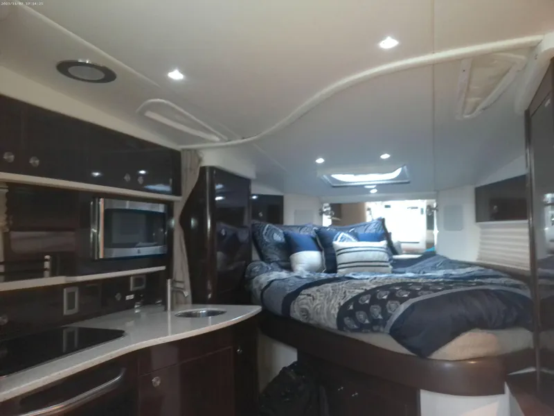 Slide: The Image of Luxurious interior of 2015 Sea Ray 330 Sundancer yacht with cozy bed and modern kitchenette. - 45