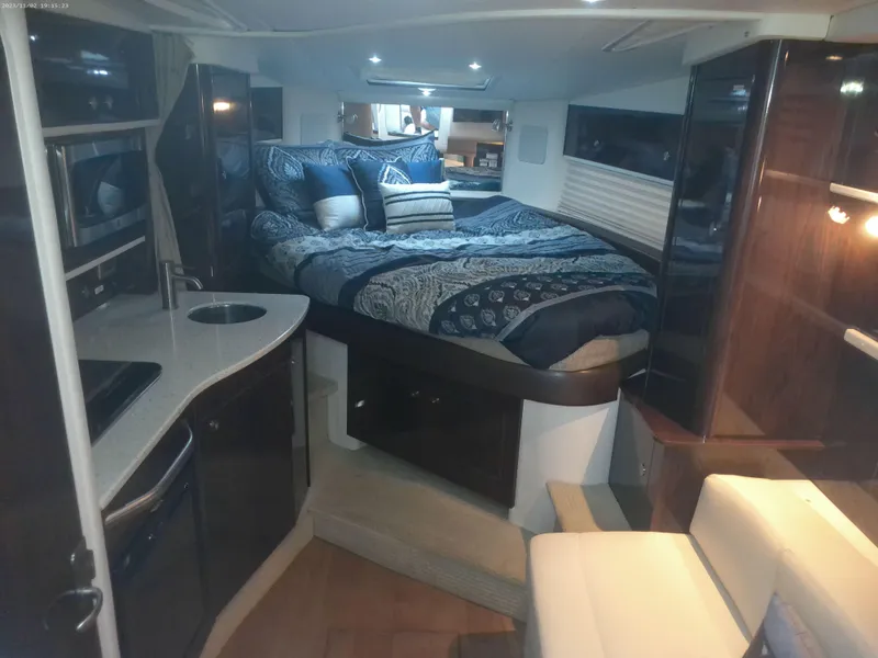 Slide: The Image of Luxurious interior of 2015 Sea Ray 330 Sundancer yacht with cozy bed and kitchenette. - 47