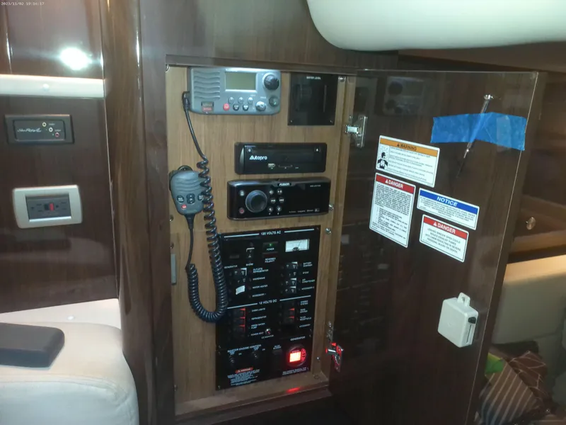 Slide: The Image of Control panel inside 2015 Sea Ray 330 Sundancer yacht, featuring communication and electrical systems. - 49
