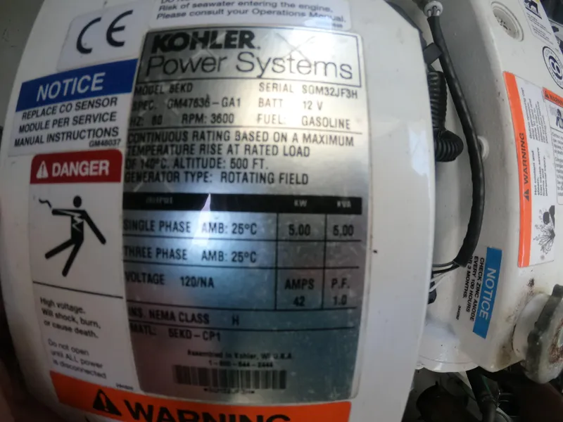 Slide: The Image of Kohler power system label on 2015 Sea Ray 330 Sundancer, showing specifications and warnings. - 69