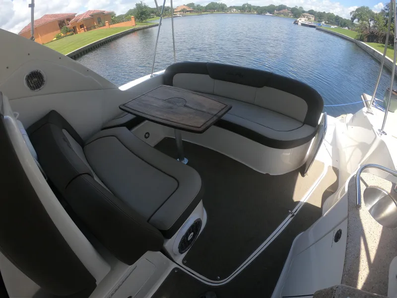 Slide: The Image of 2015 Sea Ray 330 Sundancer boat interior with seating and table by the water. - 7