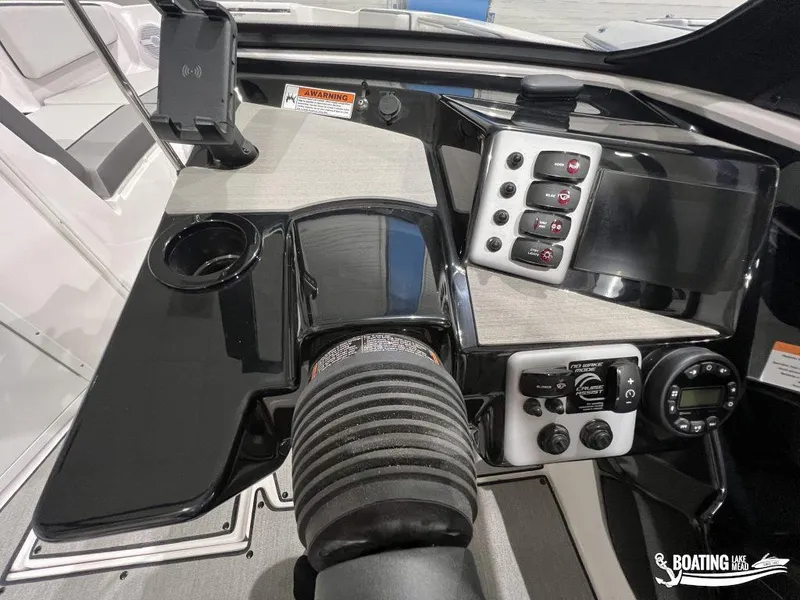 Slide: The Image of 2025 Yamaha AR220 boat dashboard with controls and cup holder. - 10