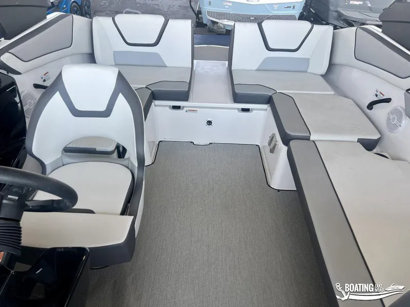 Slide: The Image of 2025 Yamaha Boats AR220 interior with modern seating and steering wheel. - 13