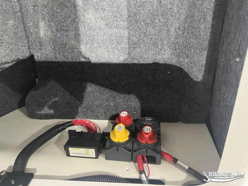 Slide: The Image of 2025 Yamaha AR220 boat battery compartment with wiring and switches. - 8
