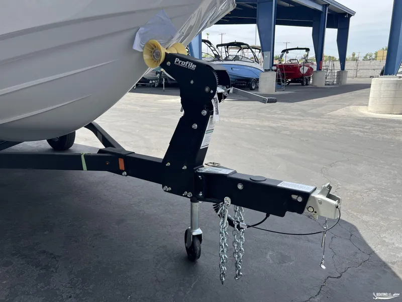 Slide: The Image of 2025 Yamaha Boats 195S trailer hitch close-up in a marina setting. - 15