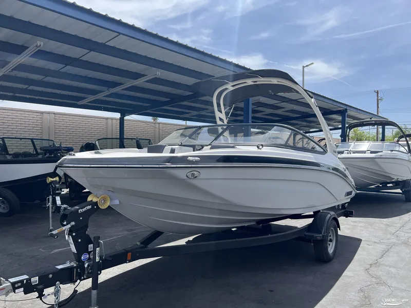 Slide: The Image of 2025 Yamaha Boats 195S under a canopy, displayed on a trailer. - 2