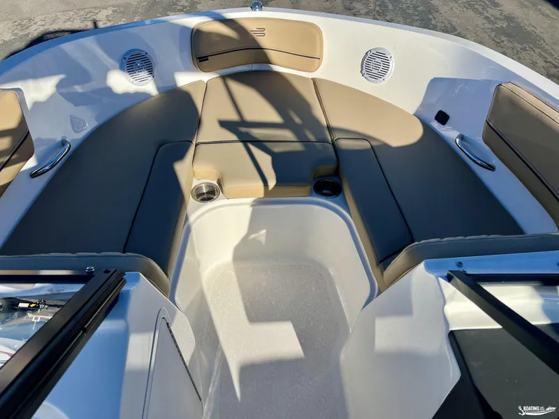Slide: The Image of 2025 Bayliner VR5 boat interior with tan seating and cup holders. - 5