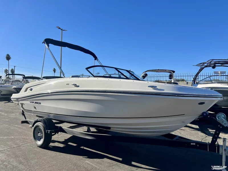 Slide: The Image of 2025 Bayliner VR5 boat on trailer under clear blue sky. - 1