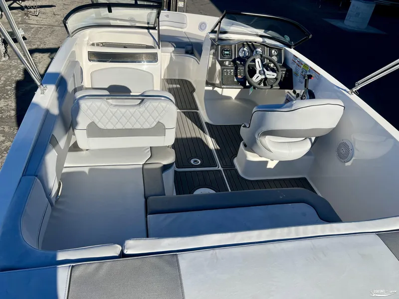 Slide: The Image of 2025 Bayliner VR5 boat interior with modern seating and steering console. - 4