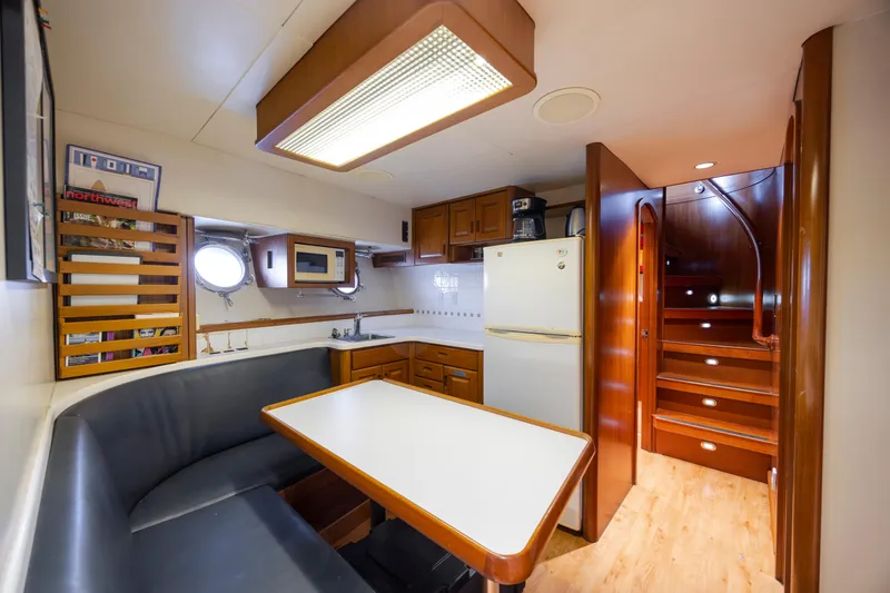 Slide: The Image of Luxury Christensen Custom yacht docked in marina, 1988 model, with urban backdrop. - 126