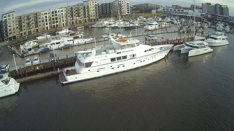 Slide: The Image of 1988 Christensen Custom yacht docked in marina, surrounded by buildings. - 5